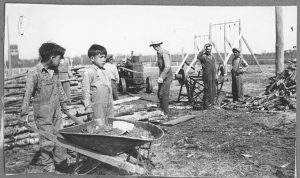 Chopping wood, Birtle School, c. 1948 (G-3665-fc-9)